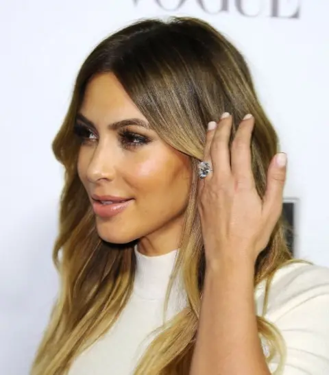 Getty Images/ Jason LaVeris Kim Kardashian poses at an even showing off her new engagement ring