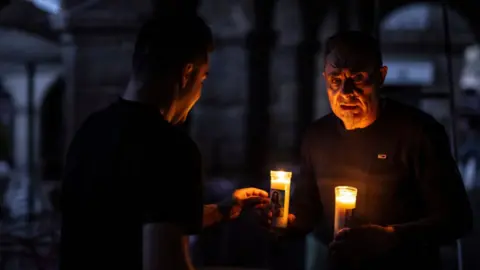EPA People use candles in the streets in Ourense, Galicia, northwestern Spain