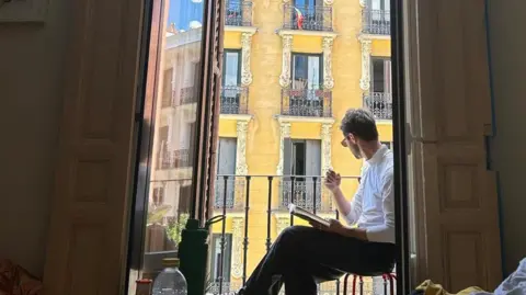 Ed Rowe Ed Rowe sits on his balcony in Madrid