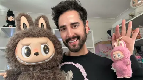 James Welsh YouTuber James Welsh poses with his Labubu toys
