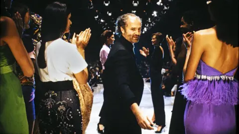 Paolo Castaldi Gianni Versace on a runway in Milan 1990