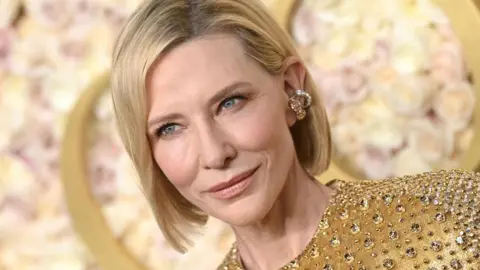 Getty Images Cate Blanchett wearing a gold dress at the 2025 Golden Globes in Hollywood