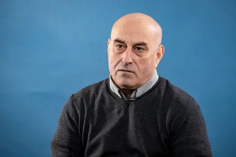 Getty Images / Marc Piasecki Yunice Abbas, a man, looking at a camera with a serious face