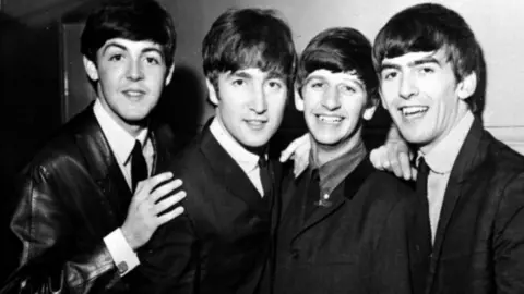 PA Media A black and white photograph of the Beatles in the early 1960s, with Paul McCartney, John Lennon, Ringo Starr and George Harrison pictured left to right.