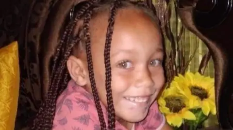 Executive Mayor Andrè Truter/ Facebook Joshlin Smith, wearing her hair in braids, smiles at the camera. Sunflowers can be seen behind her.