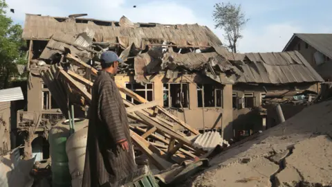 EPA A man looks the debris of demolished houses related to the family of Ahsan Ul Haq Sheikh, who officials say was involved in the Pahalgam attack, in Murran village of Pulwama, south of Srinagar, India, 26 April 2025.
