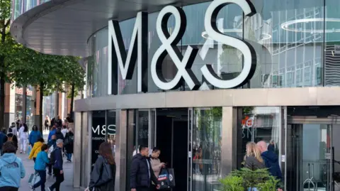 Getty Images People walking outside a Marks & Spencer store