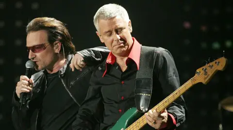 Getty Images Bono and Adam Clayton of U2 perform on stage in 2005