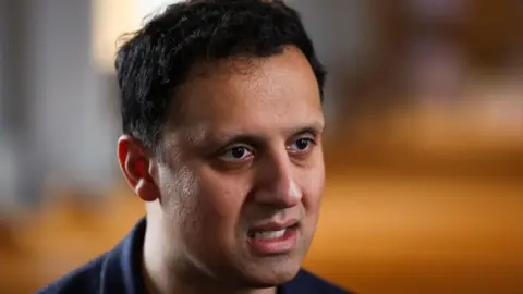 Getty Images Anas Sarwar has dark hair and is wearing a dark t-shirt