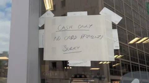 BBC A sign on a Co-op shop reading