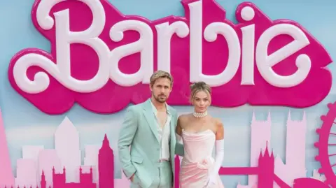 Getty Images Ryan Gosling and Margot Robbie, the stars of Barbie, at one of the film's premieres in 2023. He is wearing a mint green suit an she is wearing a light pinj strapless dress.