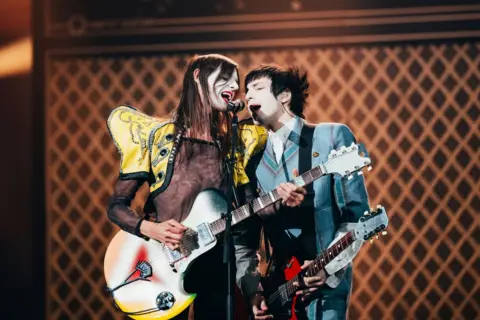 Sarah Louise Bennett Italy's Lucio Corsi (left) recreated David Bowie's iconic Top Of The Pops performance with Mick Ronson during his song, Volevo Essere Un Duro