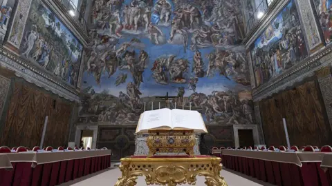 VATICAN MEDIA / HANDOUT A view from the Sistine Chapel, specially arranged ahead of the Papal Conclave to elect the new pope as voting desks for the 133 cardinals have been placed beneath Michelangelo's frescoes.
