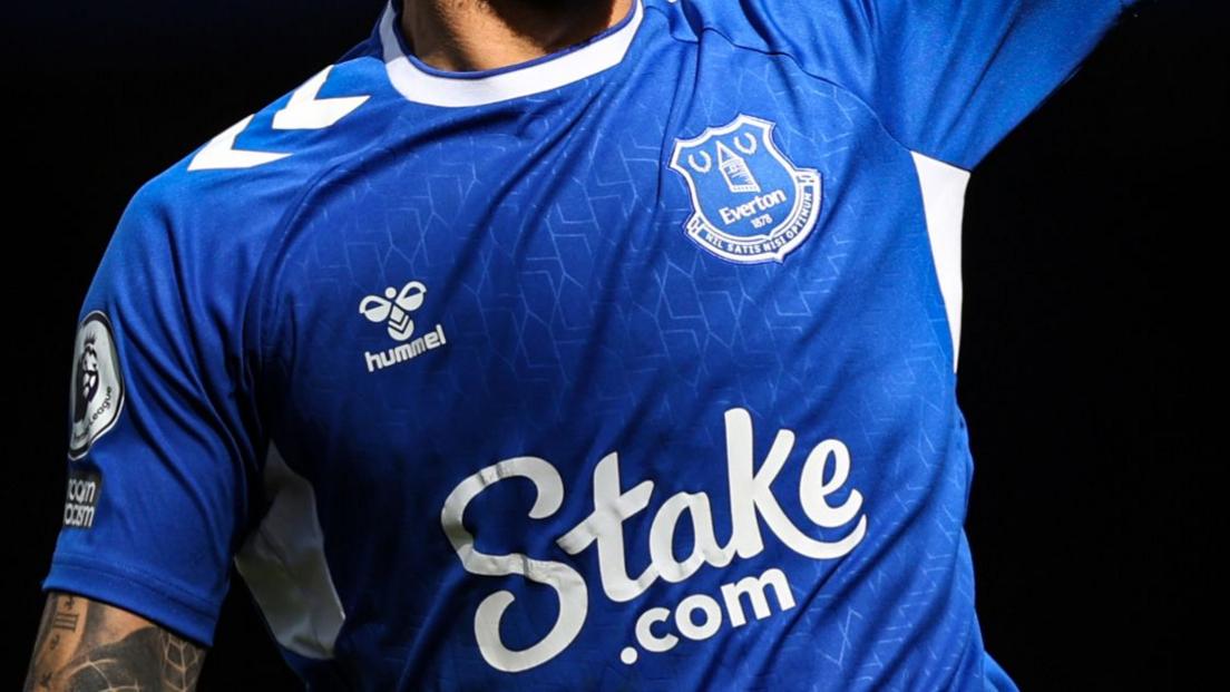 A betting company advertising on the Everton shirt.