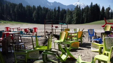 Reuters Chairs and tables are scattered at the site of a suspected militant attack on tourists in Baisaran near Pahalgam in south Kashmir's Anantnag district, April 24, 2025. REUTERS/Adnan Abidi