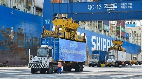 China News Service/VCG via Getty Images Trucks transfer containers at Nansha Port on April 29, 2025 in Guangzhou, Guangdong Province of China. G